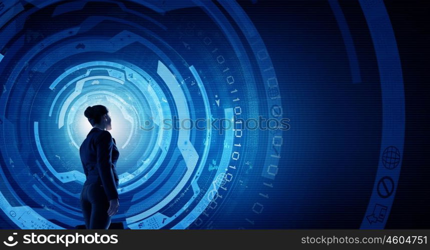 Modern global technologies. Back view of businesswoman with suitcase in hands looking at virtual panel