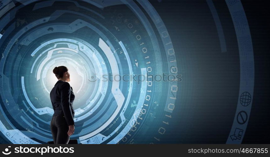 Modern global technologies. Back view of businesswoman with suitcase in hands looking at virtual panel