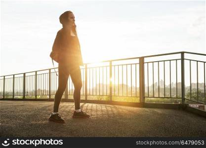 Modern healthy lifestyle. A woman in sportswear on evening city background