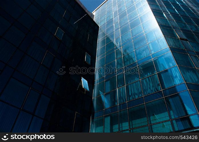 modern high-rise building with mirrored walls. modern multi-story building with mirrored walls on a sunny clear day