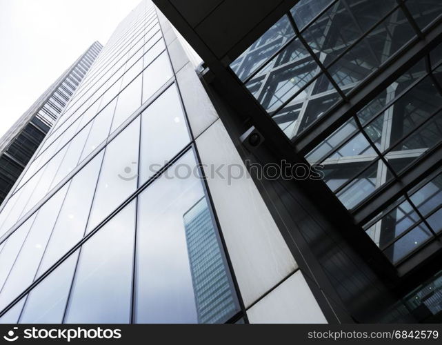 modern high rise buildings with reflections of sky and clouds