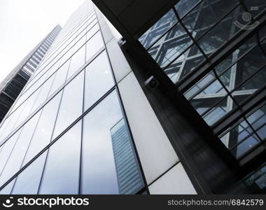 modern high rise buildings with reflections of sky and clouds