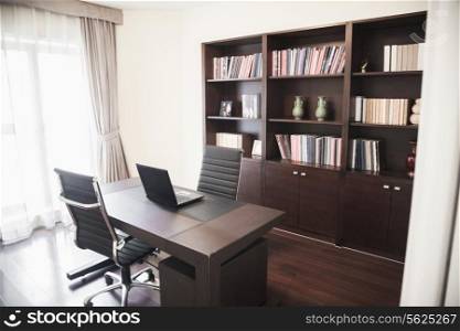 Modern home office with bookshelves.