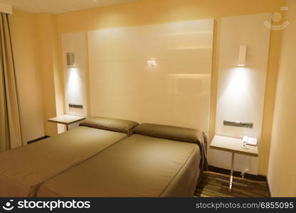 modern hotel room with bed and pillows