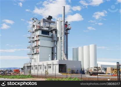 Modern industrial building of manufacturing plant against blue sky