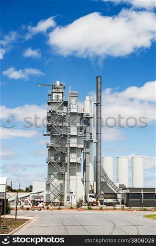 Modern industrial building of manufacturing plant against blue sky