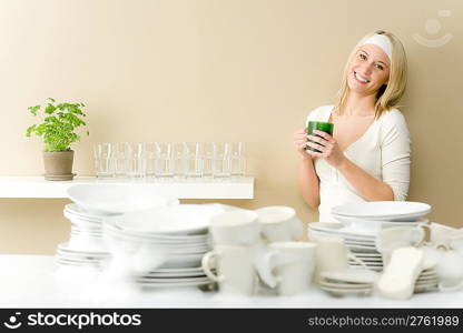 Modern kitchen - happy woman washing dishes having coffee break