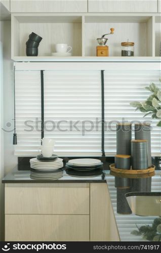 Modern kitchen interior, black worktop with wall shelf