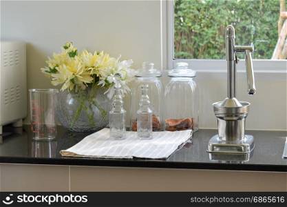 modern kitchenware and utensils on the black granite counter top