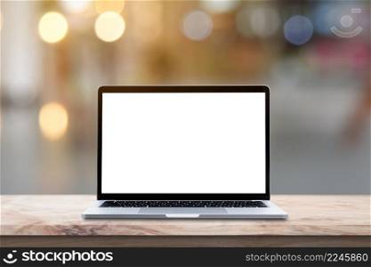 Modern Laptop computer with blank screen on wood table over blur bokeh light background.