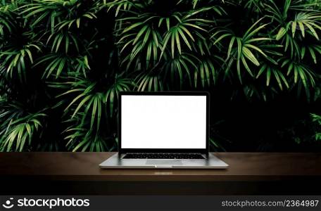 Modern laptop isolated on green leaf background. 3D illustration.