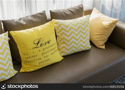 modern living room design with brown sofa and yellow pillows