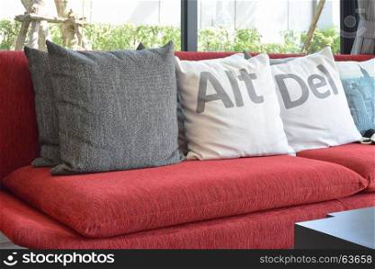 modern living room design with pillows on the red sofa and decorative lamp
