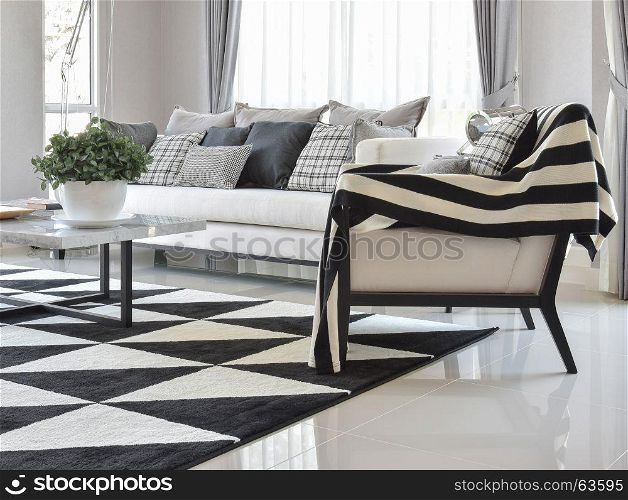 modern living room interior with black and white checked pattern pillows and carpet