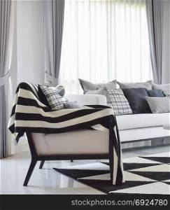 modern living room interior with black and white checked pattern pillows and carpet