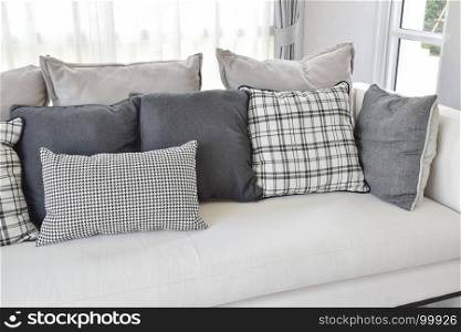 modern living room interior with black and white checked pattern pillows on sofa
