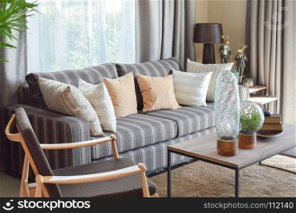 modern living room interior with striped pillows on a casual sofa at home