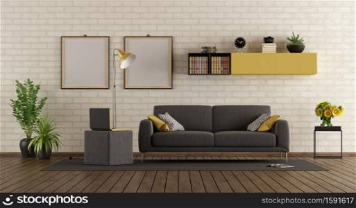 Modern living room with gray sofa,laptop on footstool and brick wall - 3d rendering. Modern living room with sofa and brick wall