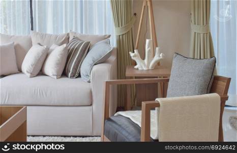 modern living room with grey armchair and brown sofa at home