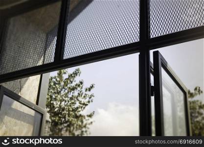 Modern loft window with natural outside view, stock photo