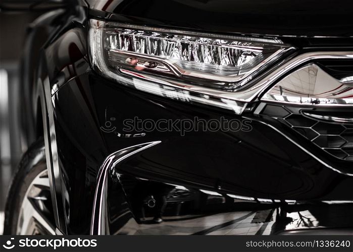 Modern luxury car close-up. Concept of expensive, sports auto. Headlight lamp of new cars,copy space. A modern and elegant car illuminated. Modern luxury car close-up. Concept of expensive, sports auto. Headlight lamp of new cars,copy space. A modern and elegant car illuminated.