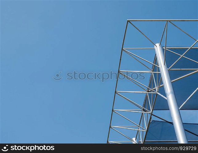 Modern metal frame with the canopy canvas of the exhibition building under the clear blue sky.