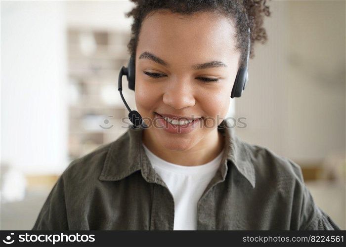 Modern mixed race teen girl student wearing headset with microphone learning foreign language online. Happy biracial schoolgirl in headphones studying on the internet. Distance education, e-learning.. Modern mixed race teen girl student wearing headset learning online. Distance education, e-learning