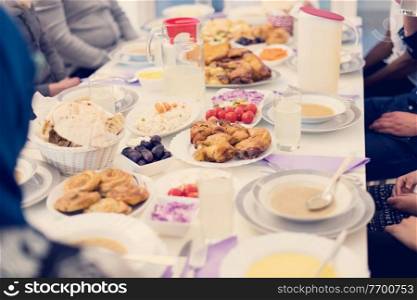 modern multiethnic muslim family enjoying eating iftar dinner together during a ramadan feast at home