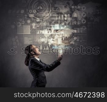 Modern multimedia technologies. Young businesswoman with tablet presenting innovative media technologies