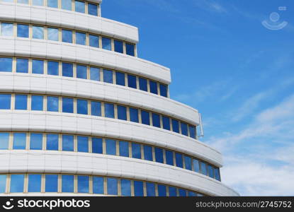 modern office building against blue sky background