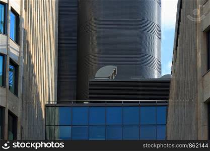 Modern office building with industrial air conditioning and ventilation systems on a roof.