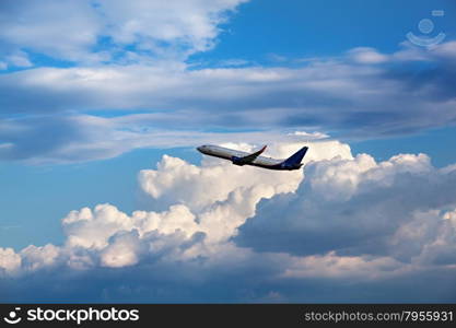 Modern passenger airliner flying in the cloudy sky