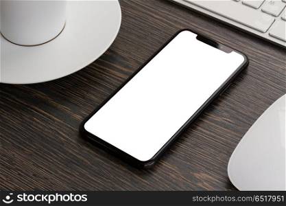 Modern phone layout. Modern mobile phone on working desk, copy space on blank screen