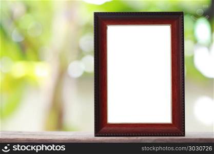 Modern Picture Frame placed on a wooden floor.. Modern Picture Frame placed on a wooden floor hand have copy space to work input your idea.