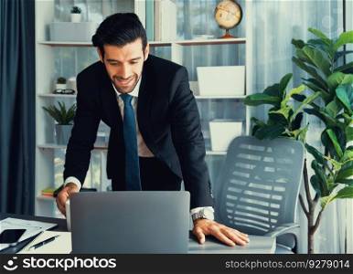 Modern professional businessman at modern office desk using laptop to work and write notes. Diligent office worker working on computer notebook in his office work space. fervent. Modern professional businessman at modern office desk. fervent