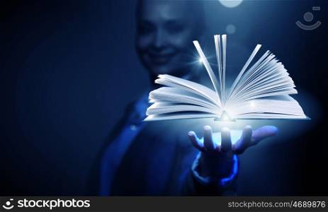 Modern reading. Close up of businesswoman showing media book on palm
