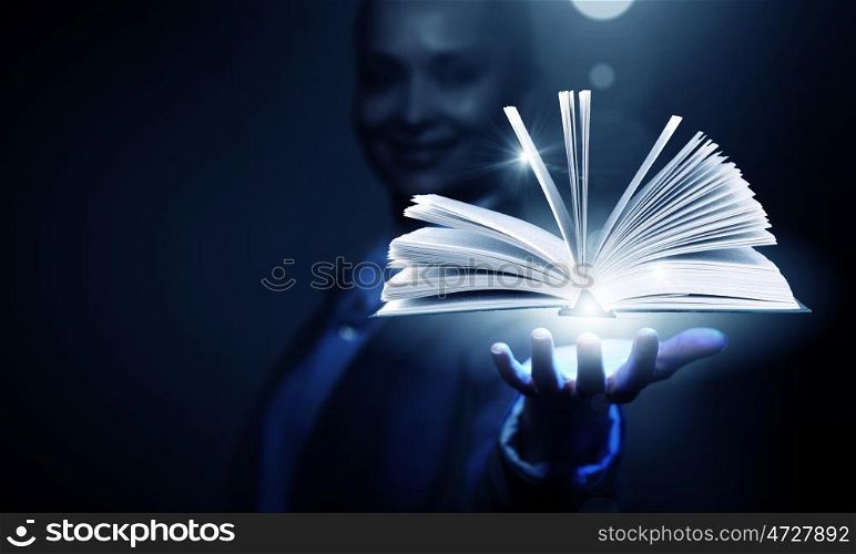 Modern reading. Close up of businesswoman showing media book on palm