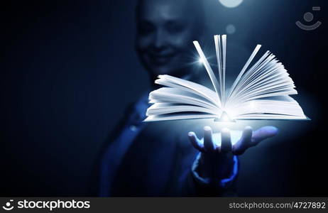 Modern reading. Close up of businesswoman showing media book on palm