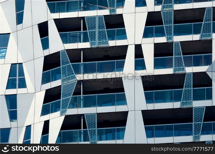 Modern residential building house facade with windows and balconies. Rotterdam (famous for modren architecture), Netherlands. Modern residential building facade with windows and balconies. Rotterdam