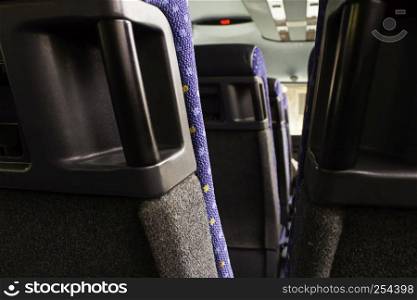 Modern seats for people in a bus, detail of public transportation