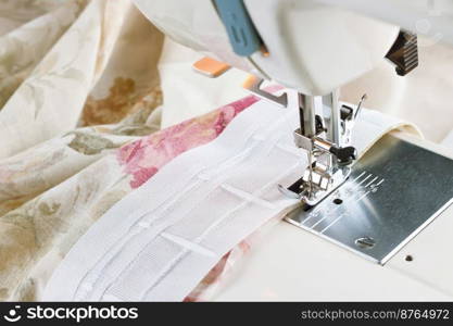 Modern sewing machine presser foot and colofrul cloth. Sewing process by curtain tape, repair. Close up photo with copy space for text. Modern sewing machine, sewing process