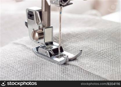 Modern sewing machine presser foot with linen fabric and thread, closeup. Sewing process clothes, curtains, upholstery. Business, hobby, handmade, zero waste, recycling, repair concept