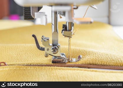Modern sewing machine with yellow velours fabric. Sewing process clothes, curtains upholstery. Business, hobby, handmade, zero waste, recycling, repair concept