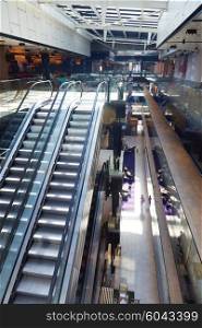 modern shopping mall store interior escalator with lens flare