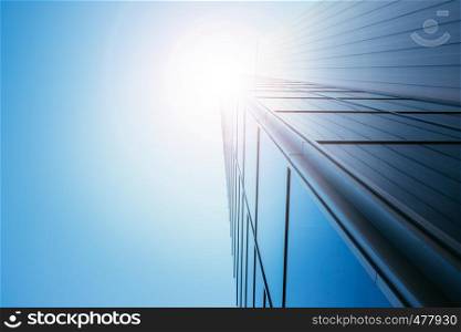 Modern skyscraper out of glass, blue sky and sunbeam