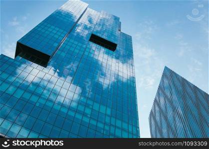 Modern skyscrapers against blue sky in Levent business district in Istanbul, Turkey - June 04, 2019, white clouds reflections on the glass windows. Financial downtown. Busy people concept. Cityscape