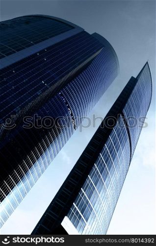 Modern skyscrapers close up and sun glare