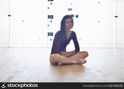 modern style ballet dancer woman posing and jumping on training in gym