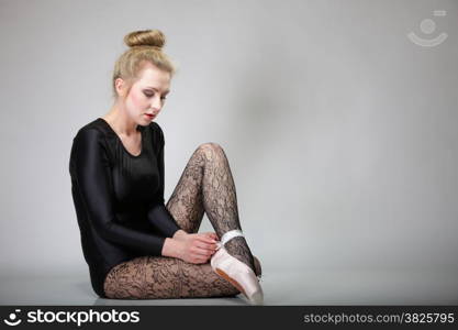 modern style beautiful woman ballet dancer full length in studio gray background