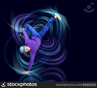 Modern style dancer. Modern style dancer posing against dark background with light effects. Illustration